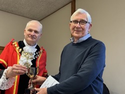 Annual award winner Alan Thomas receives Tryfan Cup for highest points in vegetables.